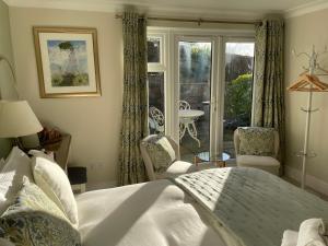 a bedroom with a bed and a view of a patio at Castlecroft Bed and Breakfast in Stirling