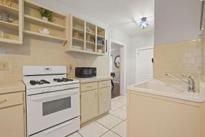 a kitchen with a white stove and a sink at Midtown 2BR Home Near DT and G Aquarium in Atlanta +8 photos