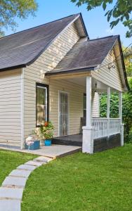 a small house with a porch and a lawn at Midtown 2BR Home Near DT and G Aquarium in Atlanta