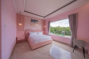 a pink bedroom with a bed and a window at Villa Karen Homestay in Uluwatu +42 photos