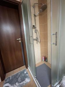a shower with a glass door in a bathroom at Snowflake Family, Parking, SPA option, 600mbps in Bansko +14 photos