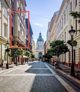 a cobblestone street in a city with a building at Basilica view prime apartment with free parking in Budapest