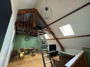 a loft conversion with a staircase and a living room at Le Havre des toits - cosy tout équipé in Boulogne-sur-Mer