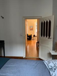 a bedroom with a door open to a living room at LES CARMES - Centre ville Toulouse in Toulouse +2 photos