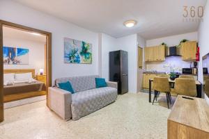 a living room with a couch and a kitchen at Lovely 1BR Apt with full amenities in Bugibba by 360 Estates in St Paul's Bay +20 photos