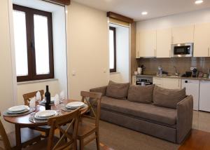 a living room with a couch and a table at Cabo do Mar Apart- Azul Beach in Espinho