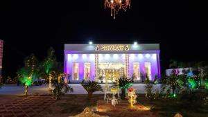 a building with christmas lights in front of it at SHIVAAY GARDEN in Kannauj +22 photos