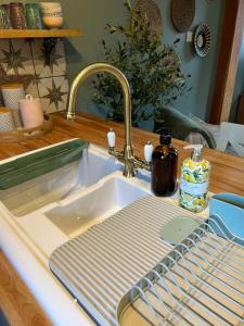 a kitchen sink with a dish drying rack next to it at Copley Cottage in Copley +34 photos