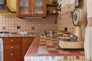 a kitchen with a sink and a tiled floor at Monolocale di Meo in Suvereto +33 photos
