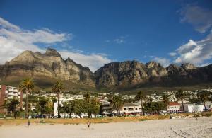 a view of a beach with mountains in the background at Big Blue Backpackers in Cape Town