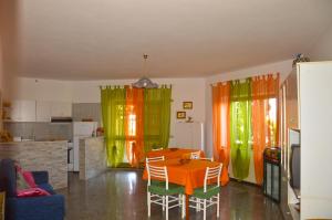 a kitchen with a table and chairs in a room at B&B Andalas in Olbia