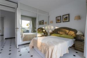 a bedroom with two beds and a large mirror at Villa Nerja in Nerja +26 photos