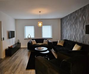 a living room with a couch and a table at Bördeapartment am Heiderand 2 in Samswegen