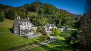 an aerial view of a large house on a green field at Tan Llan in Dolgellau