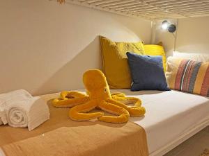 a stuffed octopus on a bed in a room at Casa Alice - Olhão By Junto ao Mar in Olhão +60 photos