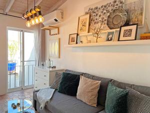 a living room with a couch and a table at Casa Salto Tavira by Junto ao Mar in Tavira