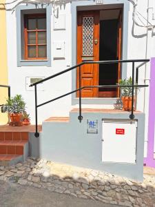 a small house with a door and a staircase at Casa Salto Tavira by Junto ao Mar in Tavira +45 photos