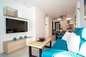 a living room with a blue couch and a table at Apartment Laguna Azul in El Mojón