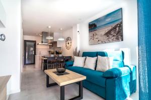 a living room with a blue couch and a table at Apartment Laguna Azul in El Mojón