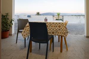 a table with chairs and a table cloth on it at Casa Vacanza Aria Pura in Rilievo