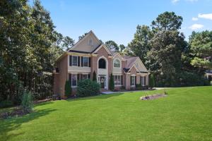 a house with a green lawn in front of it at Great Family Home Near Stone Mountain Pk Sleeps 10 in Conyers
