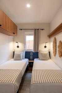 two beds in a room with a window at Toison D'or in Saint-Tropez +72 photos
