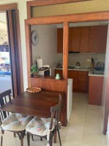 a kitchen with a wooden table and chairs and a counter at La Traiña in Adra