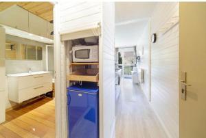 a kitchen with a microwave on top of a counter at A la montagne in Eaux-Bonnes +5 photos