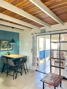 a dining room with a table and chairs in a room at Bananaquit Tobago -Stay Near the Beach in Crown Point
