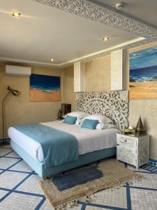 a bedroom with a large bed in a room at Riad Mellah in Essaouira