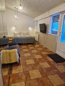 a bedroom with a bed and a flat screen tv at Studio apartment in countryside in Selfoss