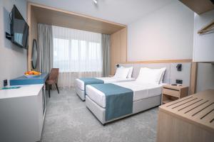 Postel nebo postele na pokoji v ubytování Nordic Resort