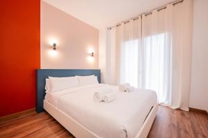 a bedroom with a white bed with two towels on it at Sweett - Carrer Bailen in Barcelona