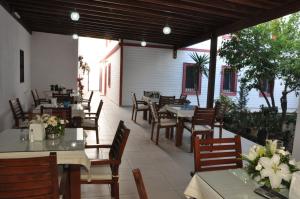 an outdoor restaurant with tables and chairs and tablesearcher at Melis Pansiyon in Bodrum City