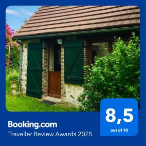 una piccola casa con una porta verde sul davanti di La maisonnette a Saint-Hilaire-sous-Romilly