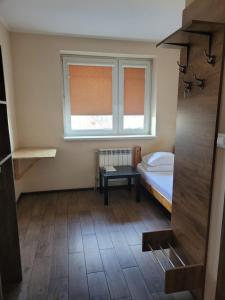 ein kleines Zimmer mit einem Bett und einem Fenster in der Unterkunft Hotel Atrans in Psary