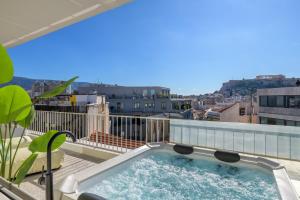 a hot tub on the balcony of a building at Acropolis Penthouse Plunge Pool in Athens
