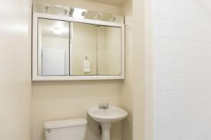 a bathroom with a sink and a toilet and a mirror at 1BR Apartment in Bostons Fenway Neighborhood in Boston +8 photos