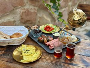 a table topped with plates of food and a basket of food at Beit Ahlan in Amman