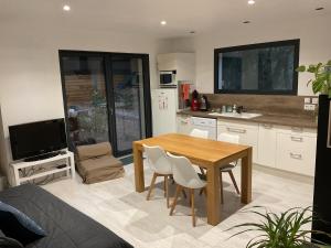 a kitchen and dining room with a table and chairs at Appartement en campagne in Saint-Marcel-de-Carreiret +4 photos