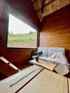 a living room with a couch and a window at Mountain Eco Shelter 9 in Funchal
