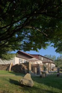 una casa con una pared de piedra y un árbol en Hotel Rohanov en Lhota nad Rohanovem