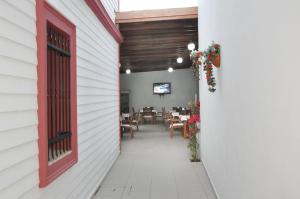 a red door on the side of a white building at Melis Pansiyon in Bodrum City