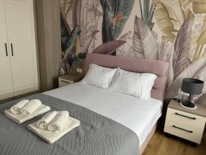 a bedroom with a bed with towels on it at Central luxury apartment ROOM 4 in Ohrid +6 photos
