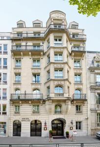 an apartment building in front of a street at Grand Hôtel Champs-Elysées in Paris