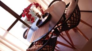 a vase with flowers in it sitting on a table at Luxury Paiva Flat in Recife
