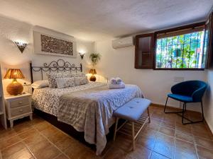 a bedroom with a bed and a chair and a window at Hotel Altea Paradise 1917 - Adults Only in Altea