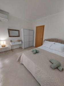 a bedroom with a large bed with two pillows on it at Villa Danai Nefeli Siviri in Siviri