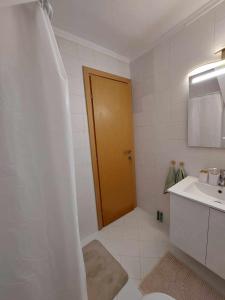 a bathroom with a sink and a brown door at Villa Danai Nefeli Siviri in Siviri
