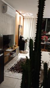 a living room with a desk and a cactus at Luxury Paiva Flat in Recife